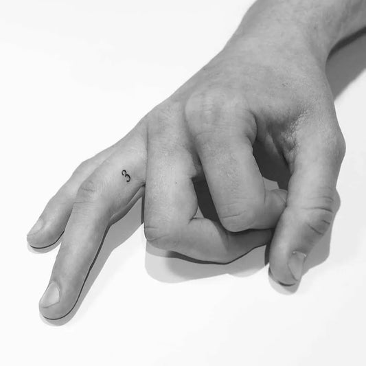 Tiny Minimalist Infinity Symbol Number Tattoo on Men Finger by @little.tattoos