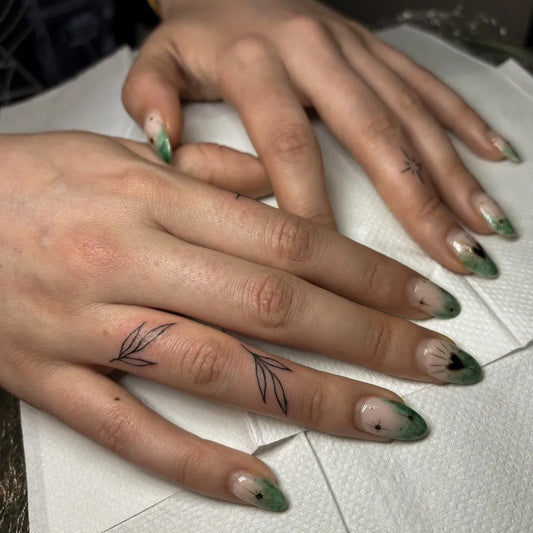 Tiny Minimalist Leaves on Women Fingers Tattoo by @ame.inks