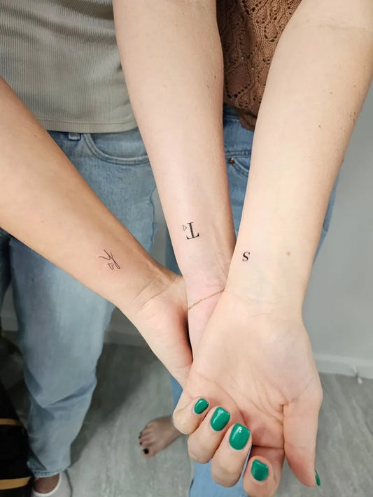 Tiny Minimalist Letters on Women Wrists Tattoo by @leeink_studio