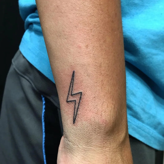 Tiny Minimalist Lightning Bolt Tattoo on Men Wrist by @eyedle.ink