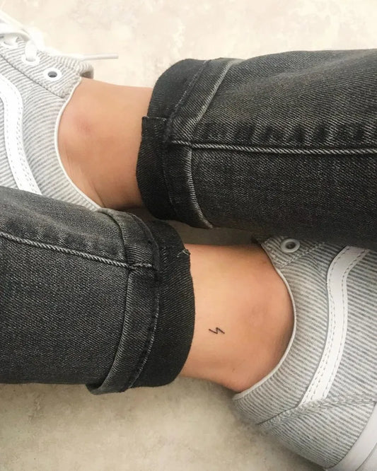 Tiny Minimalist Lightning Bolt Tattoo on Women Ankle by @nurse.maddi