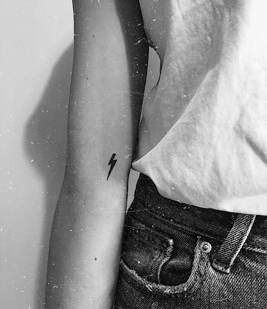 Tiny Minimalist Lightning Bolt Tattoo on Women Arm by @madelinejessicaoliver