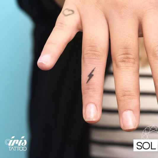 Tiny Minimalist Lightning Bolt Tattoo on Women Finger by @iristattooart