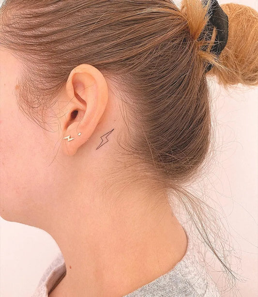 Tiny Minimalist Lightning Bolt Tattoo on Women Neck by @pollytatttoo