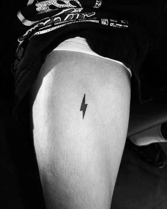 Tiny Minimalist Lightning Bolt Tattoo on Women Thigh by @infiniti.inks