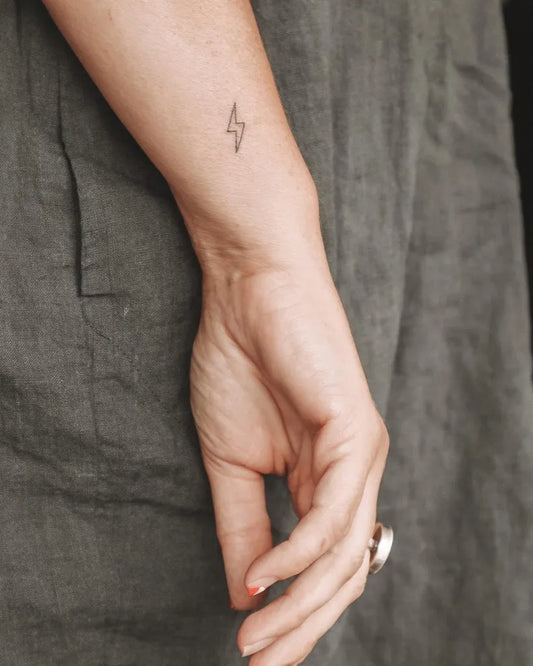 Tiny Minimalist Lightning Bolt Tattoo on Women Wrist by @chtattooing