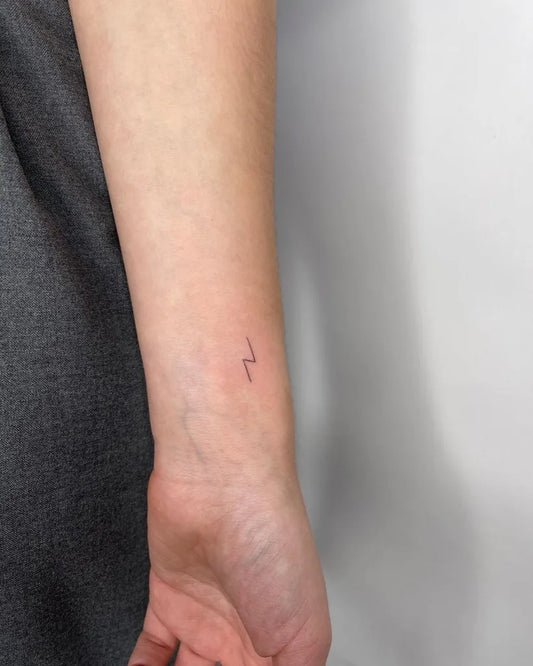 Tiny Minimalist Lightning Bolt Tattoo on Women Wrist by @francielitattooart