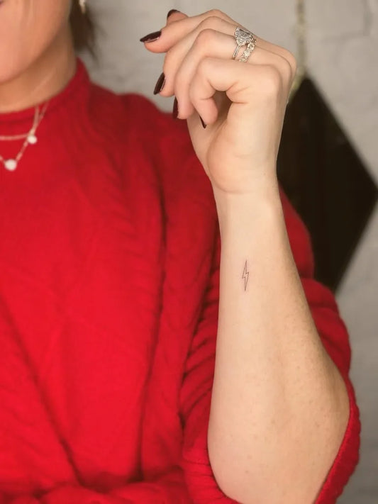 Tiny Minimalist Lightning Bolt Tattoo on Women Wrist by @tattoovasquez