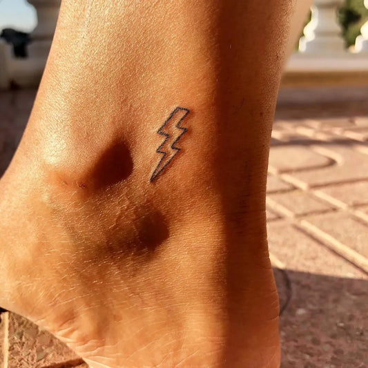 Tiny Minimalist Lightning Tattoo on Women Ankle by @kosmarta