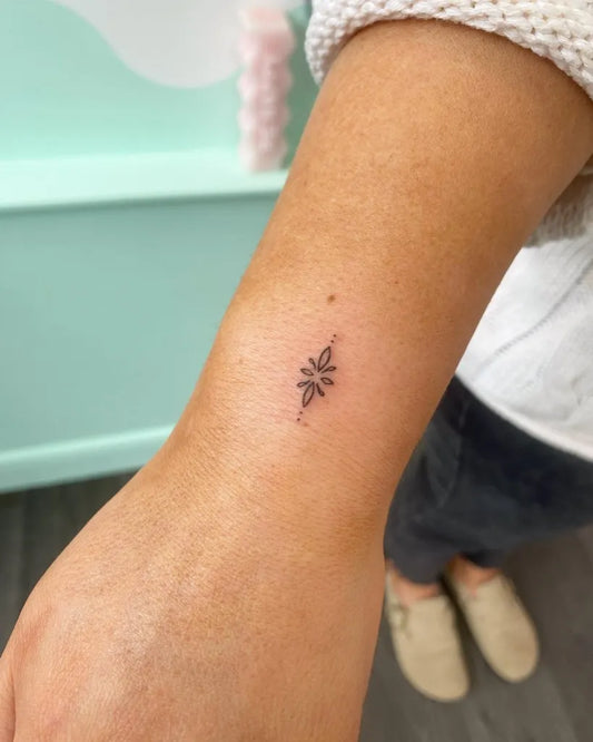 Tiny Minimalist Lotus on Women Wrist Tattoo by @mkirkuptattoo
