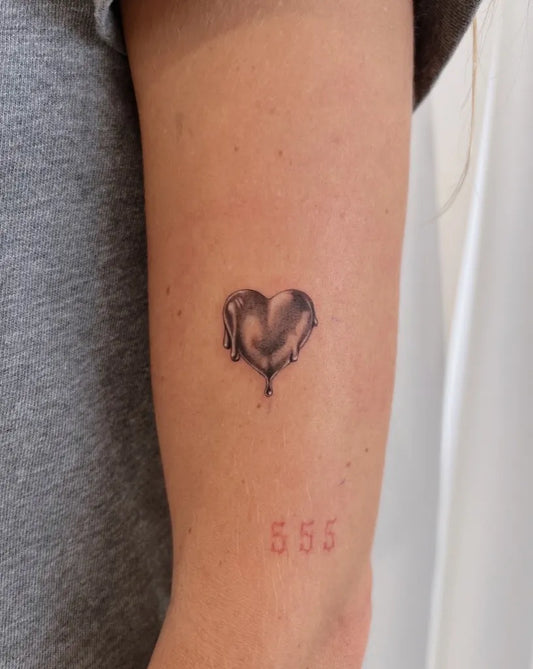 Tiny Minimalist Melting Heart Numbers on Women Arm Tattoo by @inkbysoy
