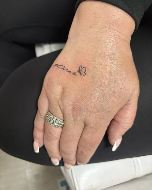 Tiny Minimalist Name Butterfly on Women Hand Tattoo by @inkandbeauty_nz