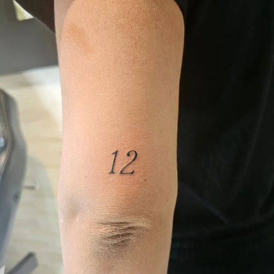 Tiny Minimalist Number Tattoo on Men Arm by @liciabracciante