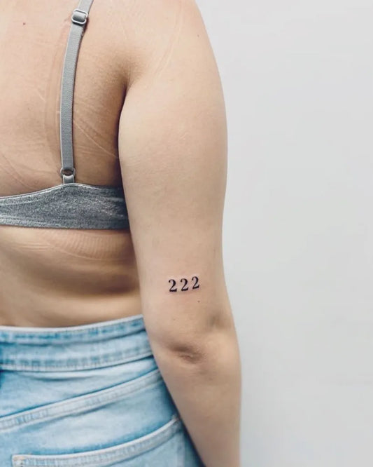 Tiny Minimalist Number Tattoo on Women Arm by @ca_tattooartist