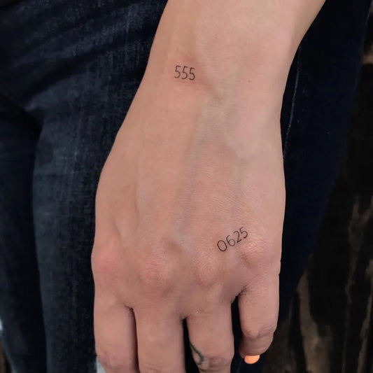Tiny Minimalist Numbers Tattoo on Women Wrist by @goldencobratattoo