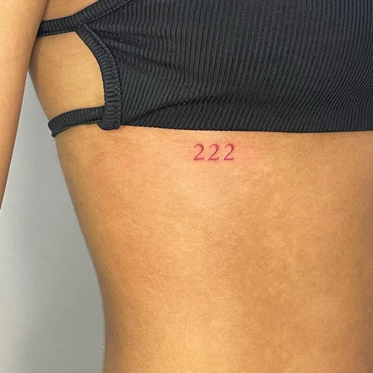 Tiny Minimalist Numbers Women Rib by @gigi.tattoos