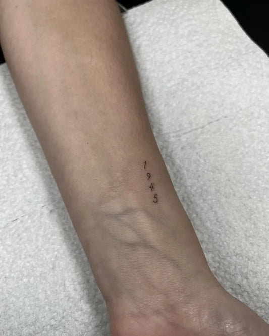 Tiny Minimalist Numbers on Women Wrist Tattoo by @fierceinkandbeauty