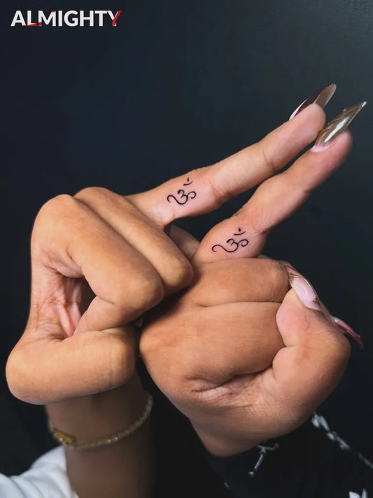 Tiny Minimalist Om Symbols on Women Fingers Tattoo by @almighty.art.studios