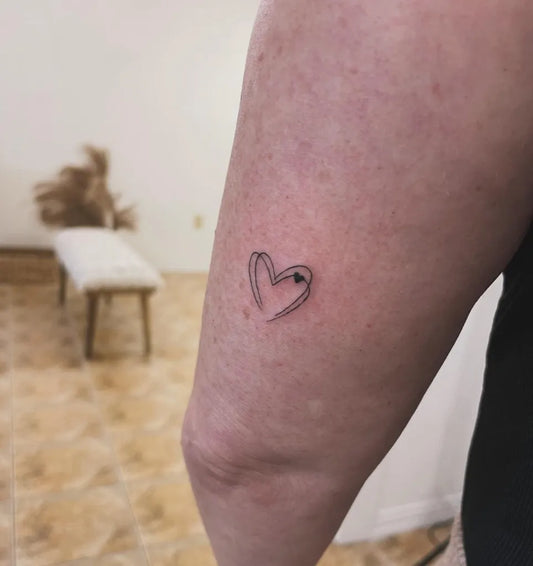 Tiny Minimalist Outline Heart on Women Arm Tattoo by @tattjamstudio