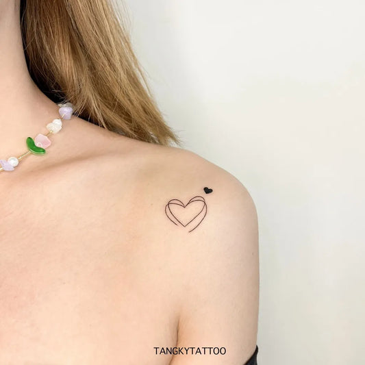 Tiny Minimalist Outline Heart on Women Shoulder Tattoo by @tangkytattoo