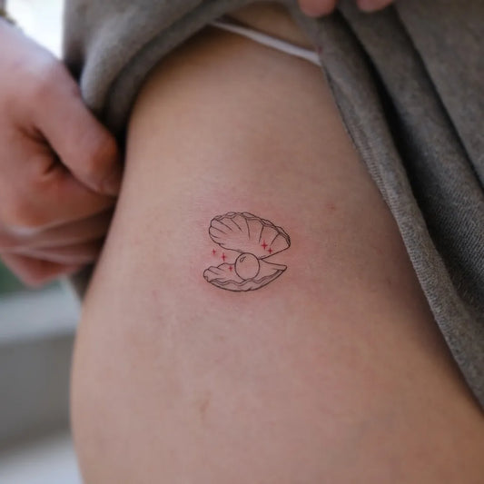 Tiny Minimalist Oyster with Pearl on Women Hip Tattoo by @helinko.tattoo