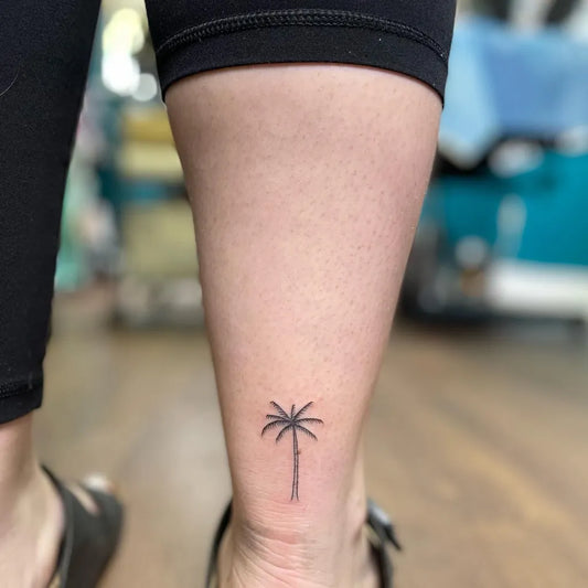 Tiny Minimalist Palm Tree Tattoo on Women Ankle by @mirotats