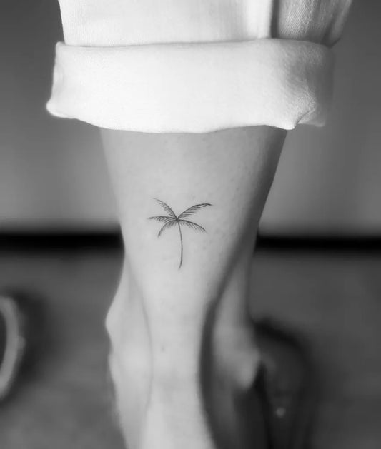 Tiny Minimalist Palm Tree Tattoo on Women Ankle by @shan.6tattoo