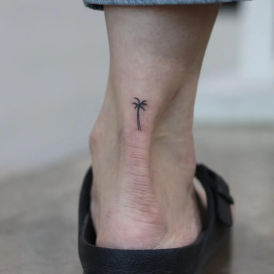 Tiny Minimalist Palm Tree Tattoo on Women Ankle by @tattooer_dogy
