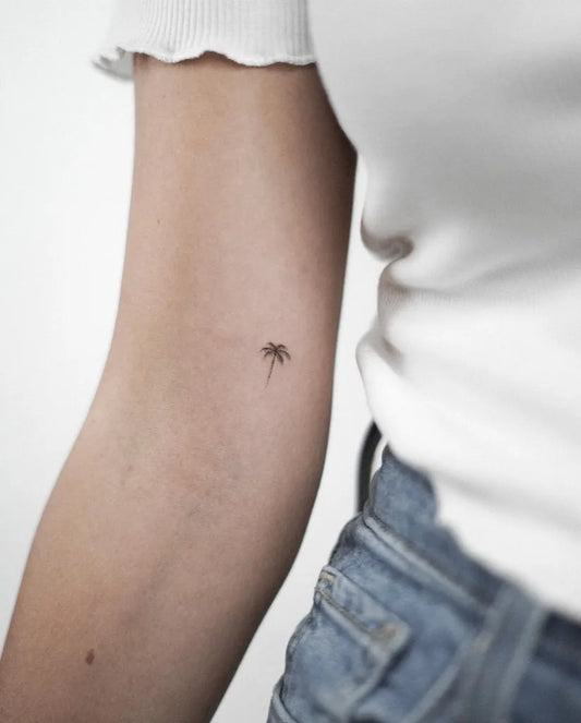 Tiny Minimalist Palm Tree Tattoo on Women Arm by @milan_maya