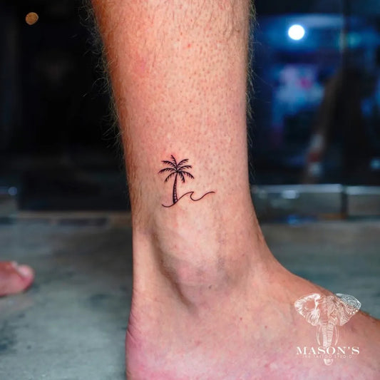 Tiny Minimalist Palm Tree and Wave Tattoo on Men Ankle by @privatestudio.tattoo.bali