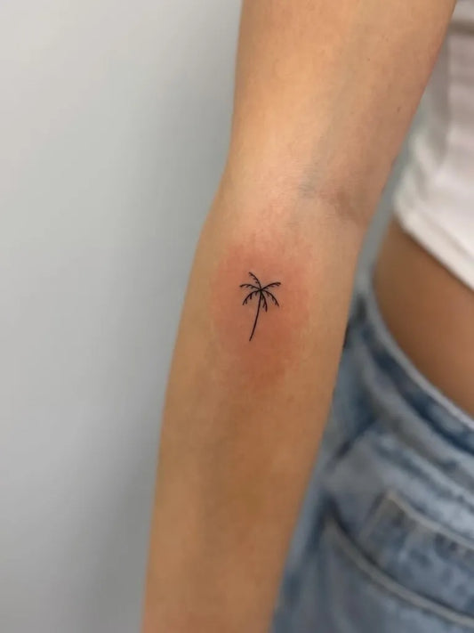 Tiny Minimalist Palm Tree on Women Arm Tattoo by @blume_fineline