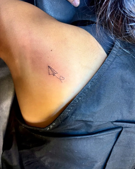 Tiny Minimalist Paper Airplane Heart on Women Shoulder Tattoo by @leartistry_ink