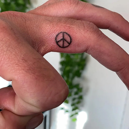Tiny Minimalist Peace Symbol on Men Finger Tattoo by @carmenmaree
