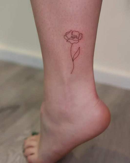 Tiny Minimalist Poppy Flower on Women Ankle Tattoo by @artrud_tattoo