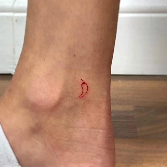 Tiny Minimalist Red Chili Pepper on Women Ankle Tattoo by @wildflowers.tattoo