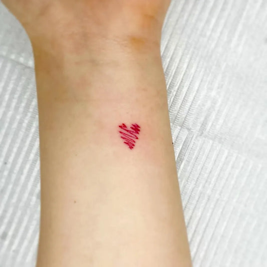 Tiny Minimalist Red Heart on Women Wrist Tattoo by @maru_ttttt