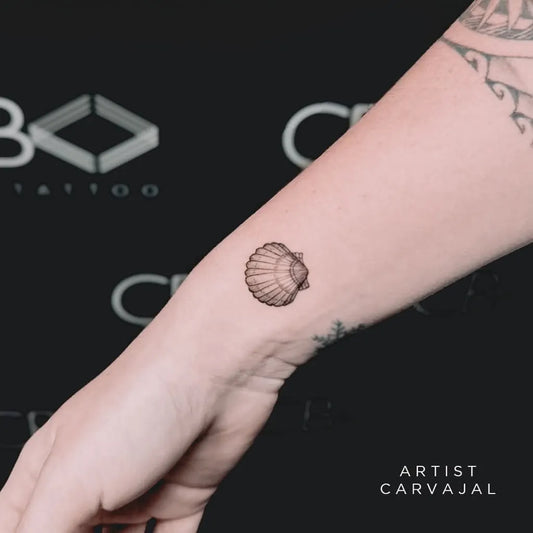 Tiny Minimalist Scallop Shell on Women Wrist Tattoo by @cbinktattoobrisbane