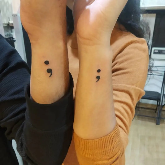 Tiny Minimalist Semicolon on Men and Women Wrist Tattoo by @angeltattoodesignstudio