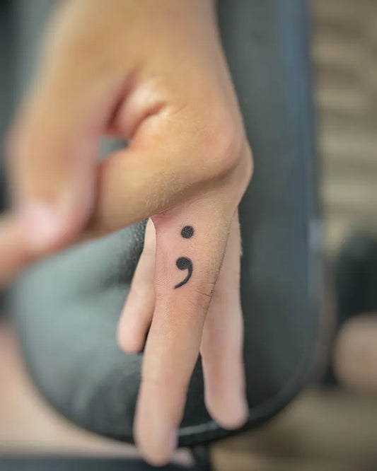 Tiny Minimalist Semicolon on Women Finger Tattoo by @rainstattooco