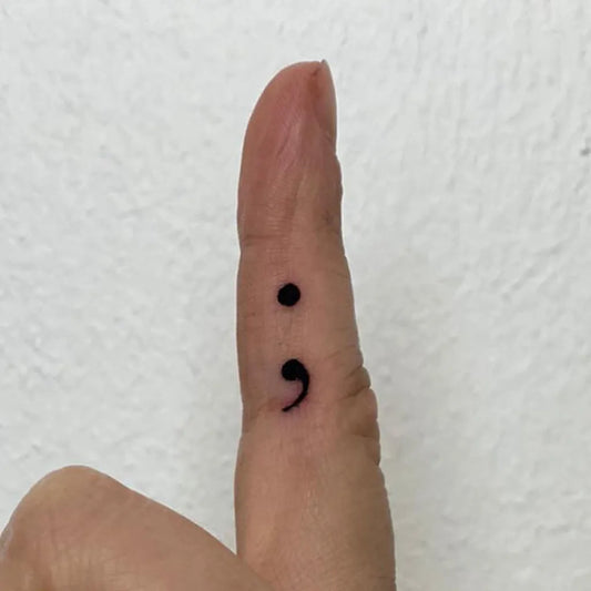 Tiny Minimalist Semicolon on Women Finger Tattoo by @yu_tattoo_berlin_