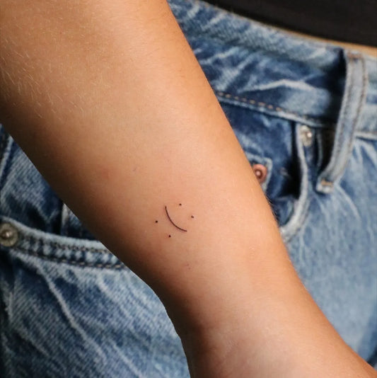 Tiny Minimalist Smiley Face on Women Arm Tattoo by @oslo.tattoo.ink