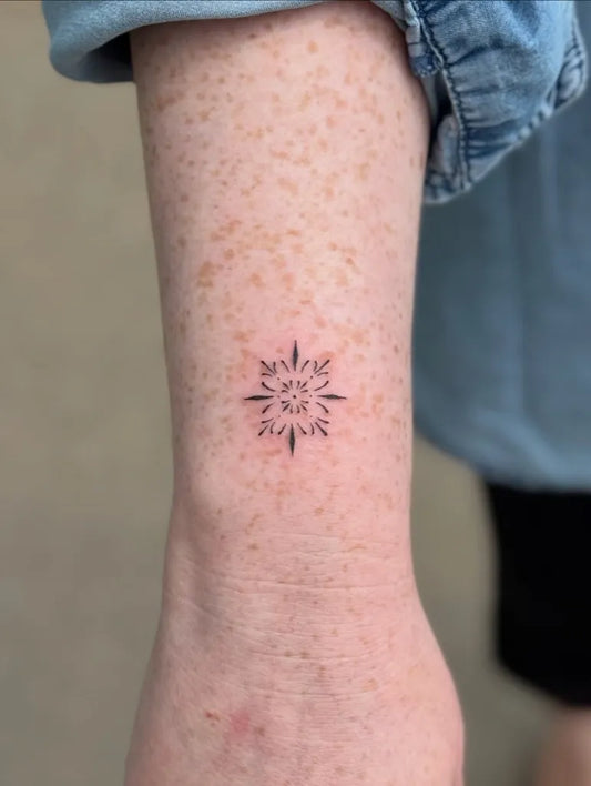 Tiny Minimalist Snowflake on Women Forearm Tattoo by @ethr.real