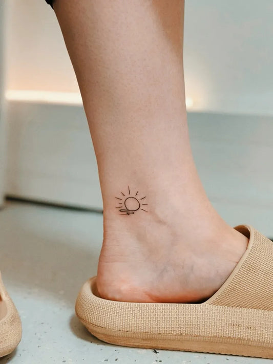 Tiny Minimalist Sun on Women Ankle Tattoo by @alina_tattoo