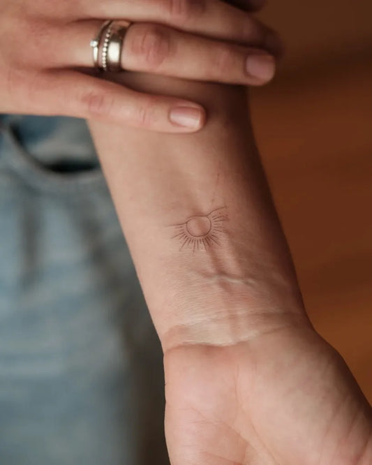 Tiny Minimalist Sun on Women Wrist Tattoo by @i_tats_