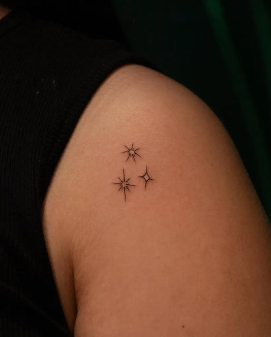 Tiny Minimalist Three Stars Tattoo on Women Shoulder by @pauline.tattoo
