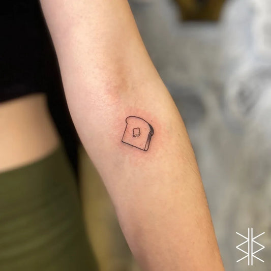 Tiny Minimalist Toast on Women Arm Tattoo by @wafflesworth