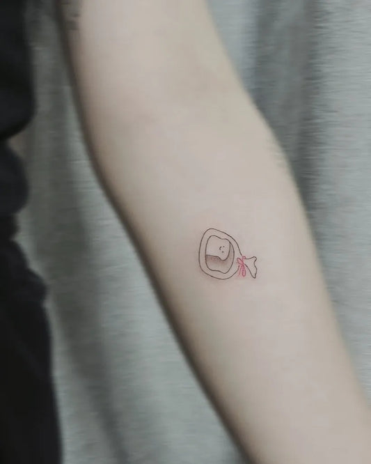 Tiny Minimalist Toast with Teeth on Women Arm Tattoo by @yiitattooist