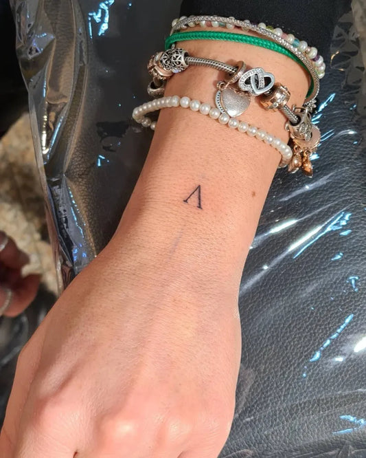 Tiny Minimalist Triangle Tattoo on Women Wrist by @buccaneertattoo