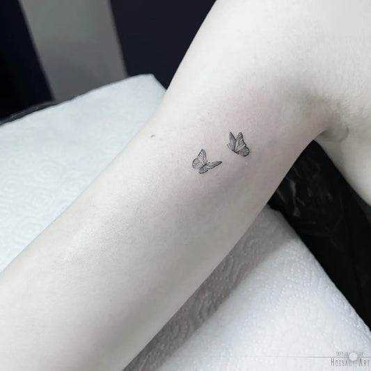 Tiny Minimalist Two Butterflies on Women Arm Tattoo by @tattoo_by_hossalart