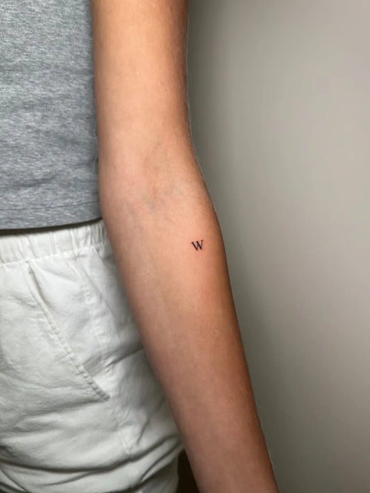 Tiny Minimalist W on Women Arm Tattoo by @tattooomanoo